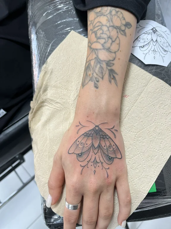 floral blackwork hand black grey elegant lotus butterfly linework tattoo Canggu Bali