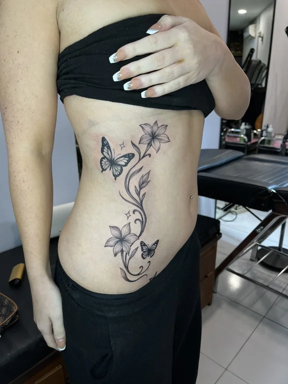 floral blackwork butterfly linework elegant black grey soft shading fine line tattoo Canggu Bali