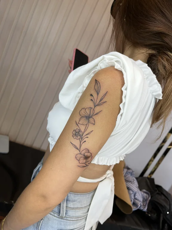 floral blackwork peony linework elegant soft shading fine line spiritual tattoo Canggu Bali