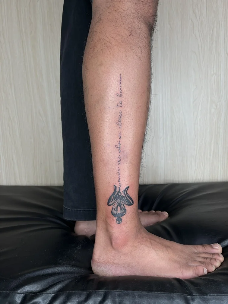 man foot tattoo black line lettering spiderman blackwork linework tattoo canggu bali