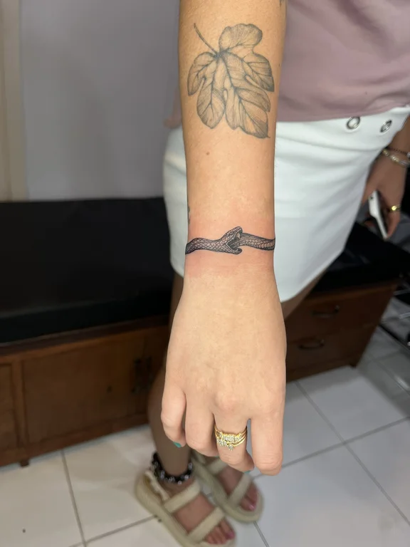 abstract minimalist snake thin line wave fine line minimal bold line tattoo Canggu Bali