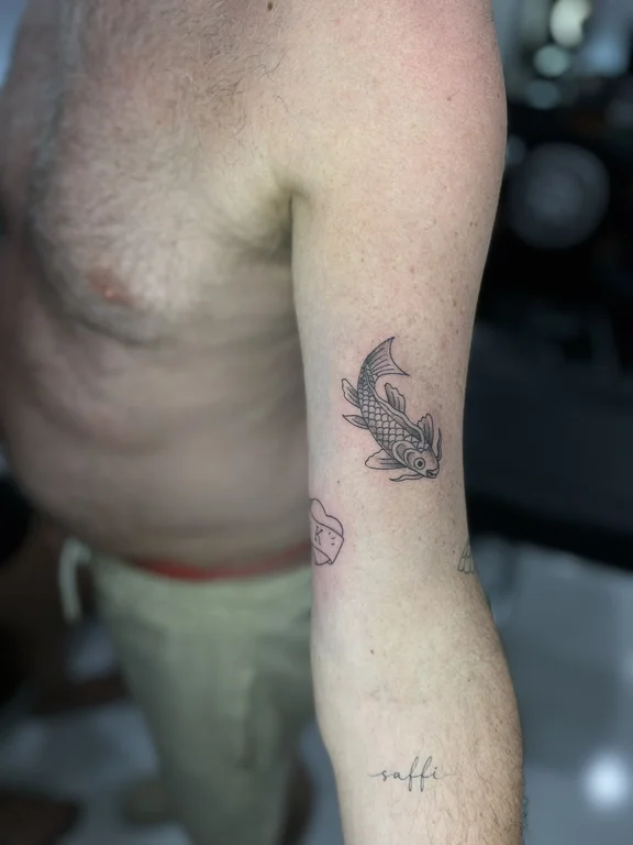 linework moon fine line black grey koi animal fish man hand tattoo tattoo canggu bali