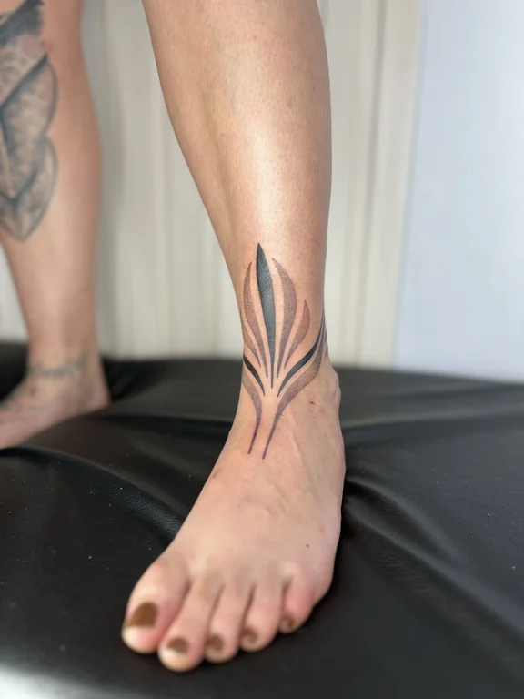 geometric minimalist phoenix fine line leaf black grey bold line soft shading tattoo Canggu Bali