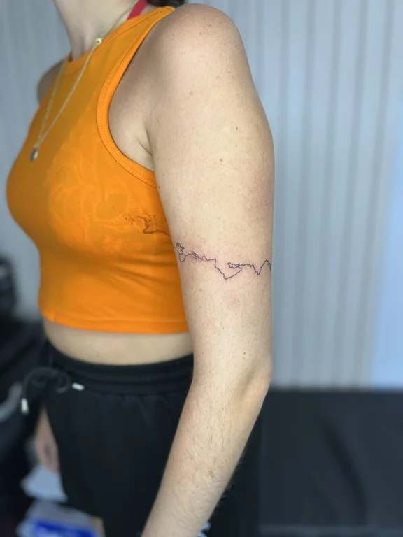 abstract fine line woman bold line wave linework minimal thin line tattoo Canggu Bali