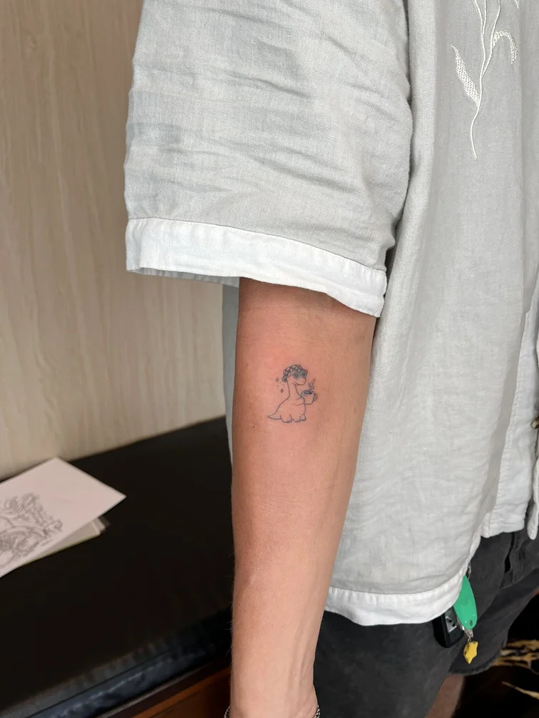 dino tattoo hand fineline linework line black blackwork cartoon tattoo canggu bali