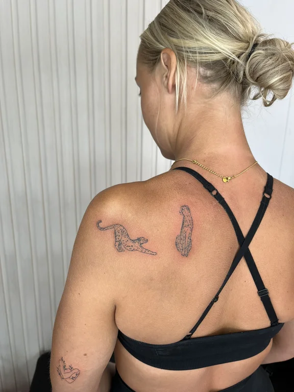 linework elegant bold line minimal woman back leopard tattoo canggu bali