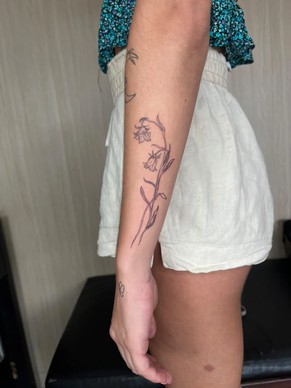 woman hand flower floral lily fine line line work line tattoo canggu bali