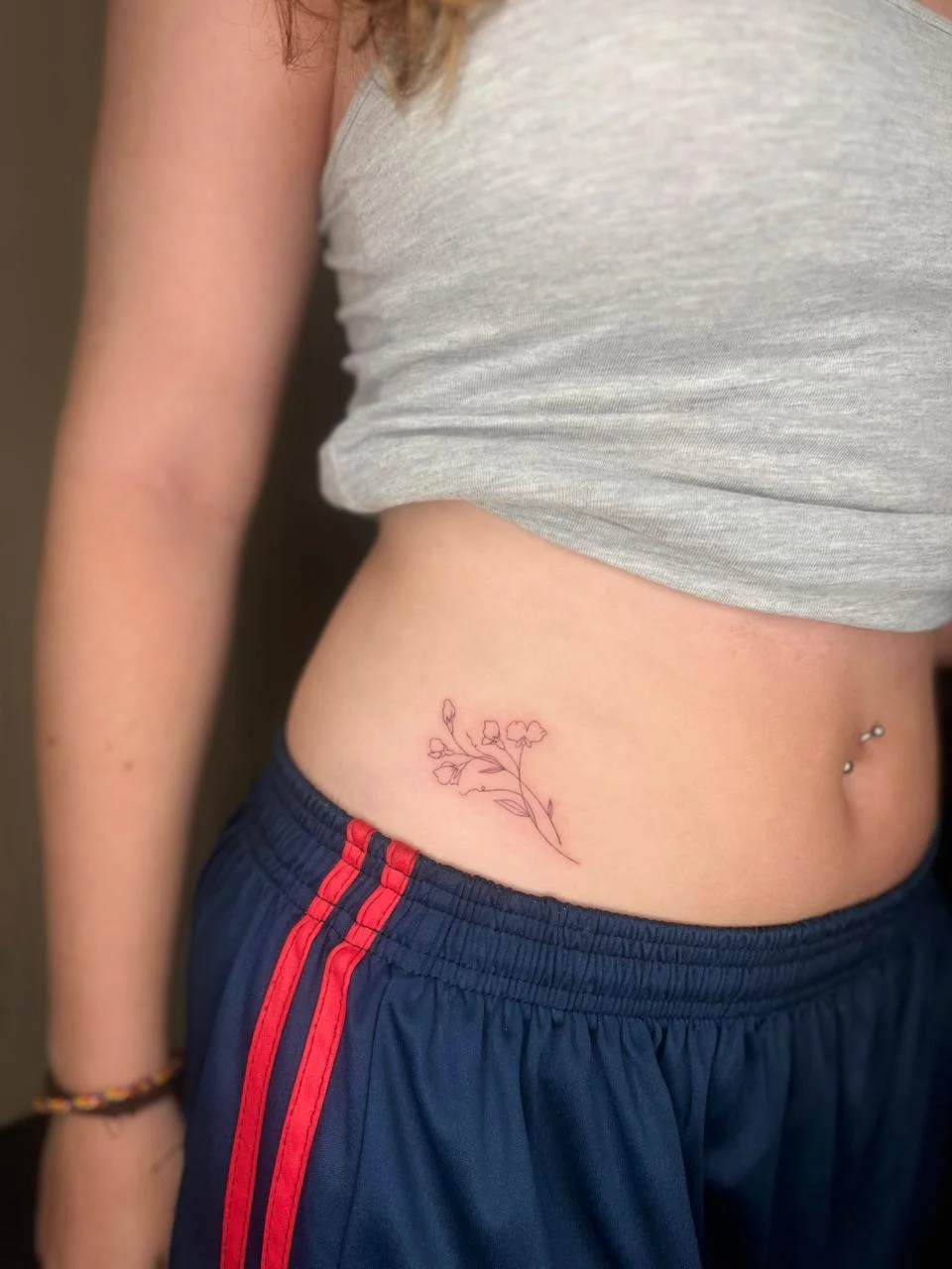 woman waist small flower fine line line work line simple elegant tattoo canggu bali