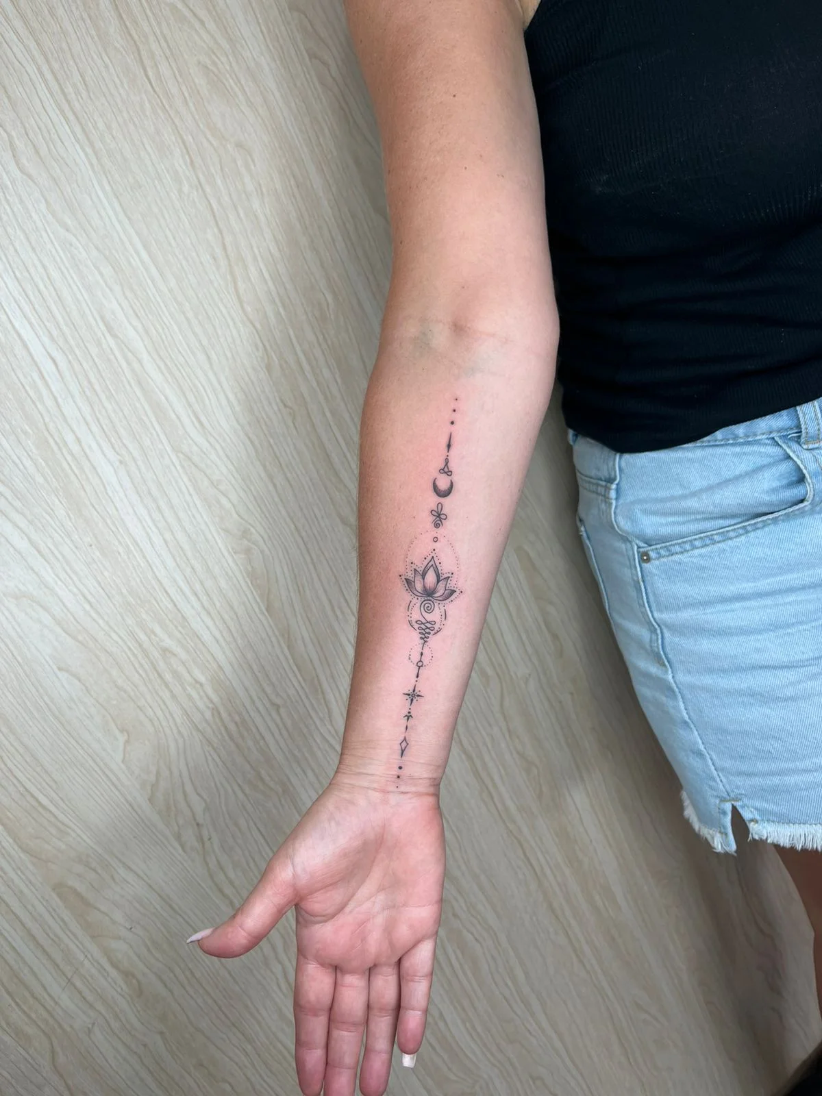 woman hand lotus fine line line work line geometric elegant tattoo canggu bali