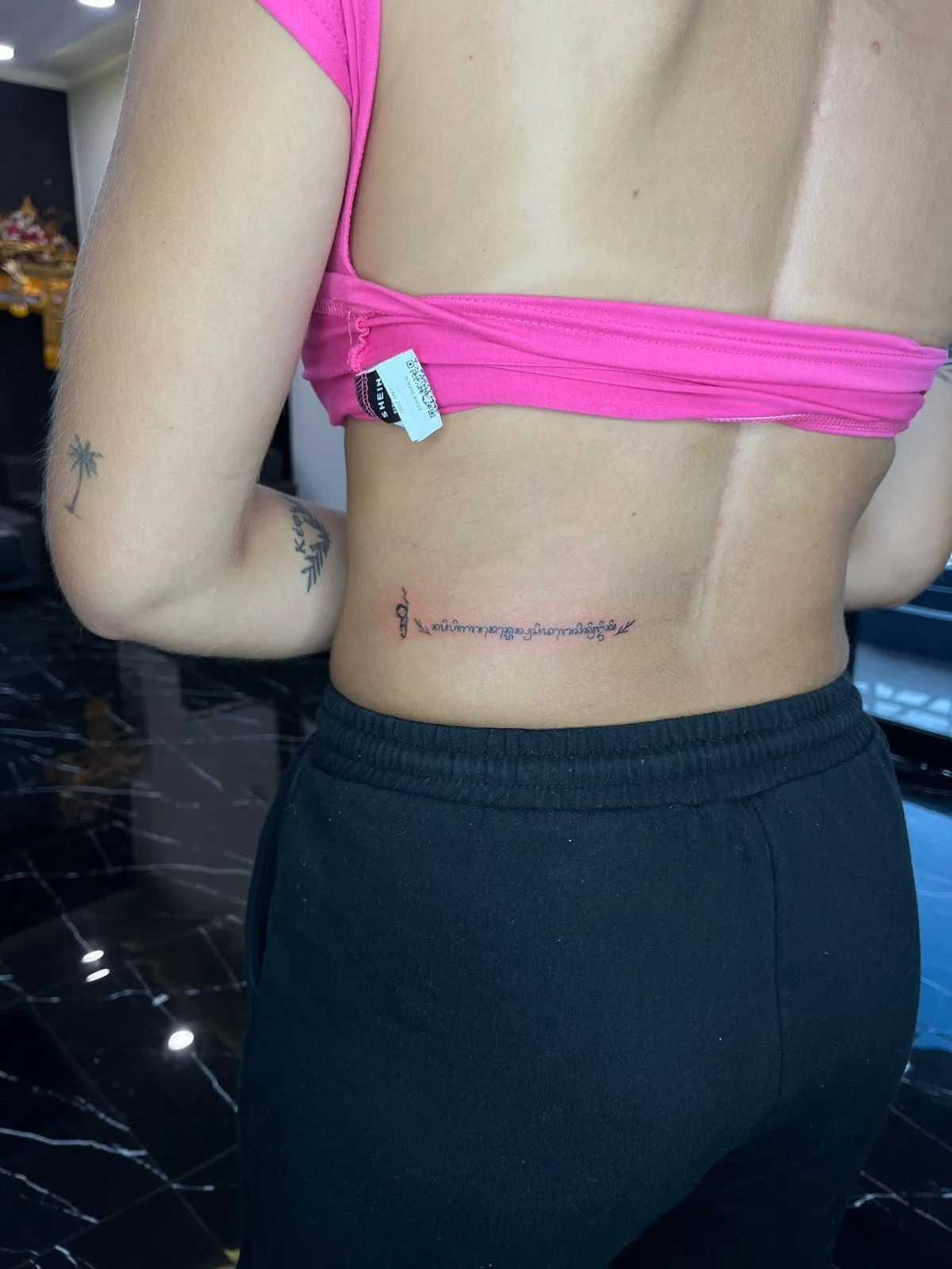 woman waist leterring small fine line line work line tattoo canggu bali