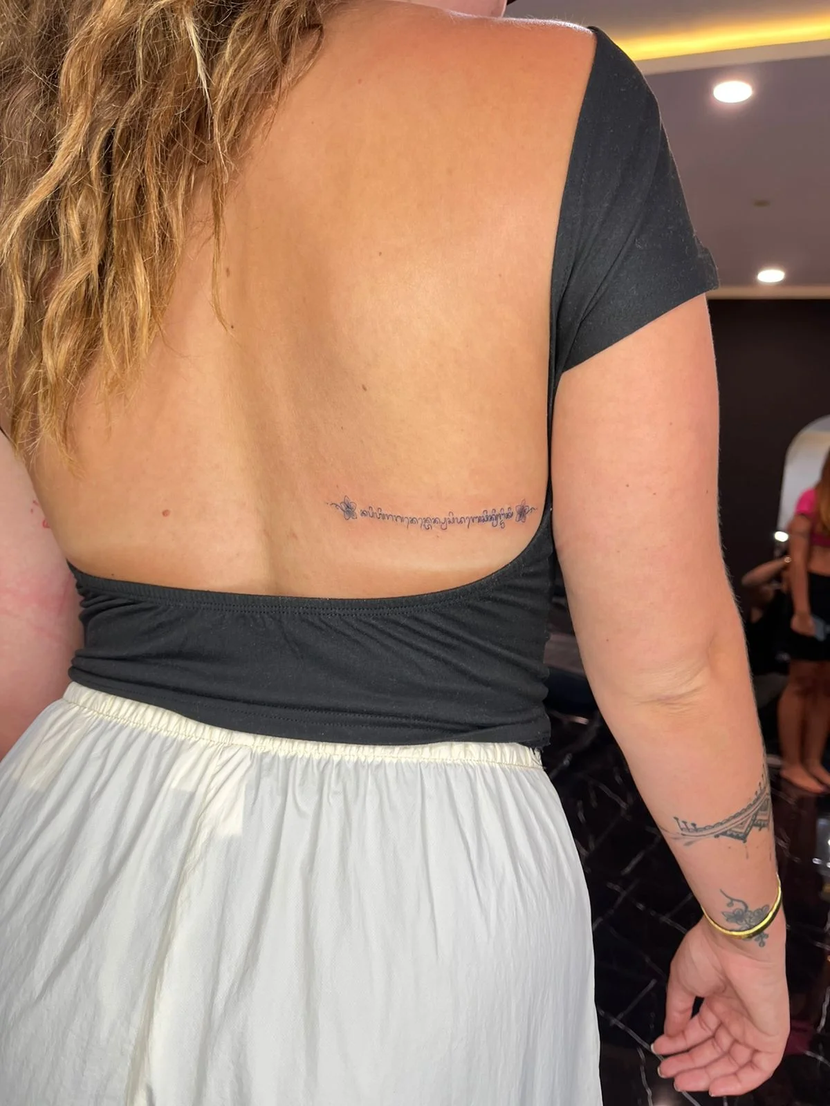 woman waist lettering fine line line work line small tattoo canggu bali