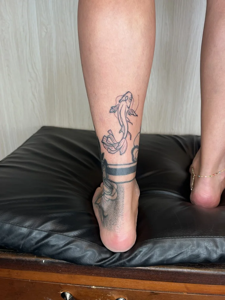 japanese animal fish koi line linework foot tattoo black tattoo canggu bali