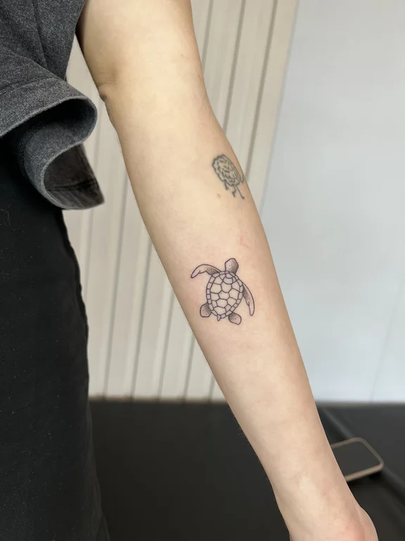 animal blackwork snake linework elegant minimal dotwork soft shading tattoo Canggu Bali