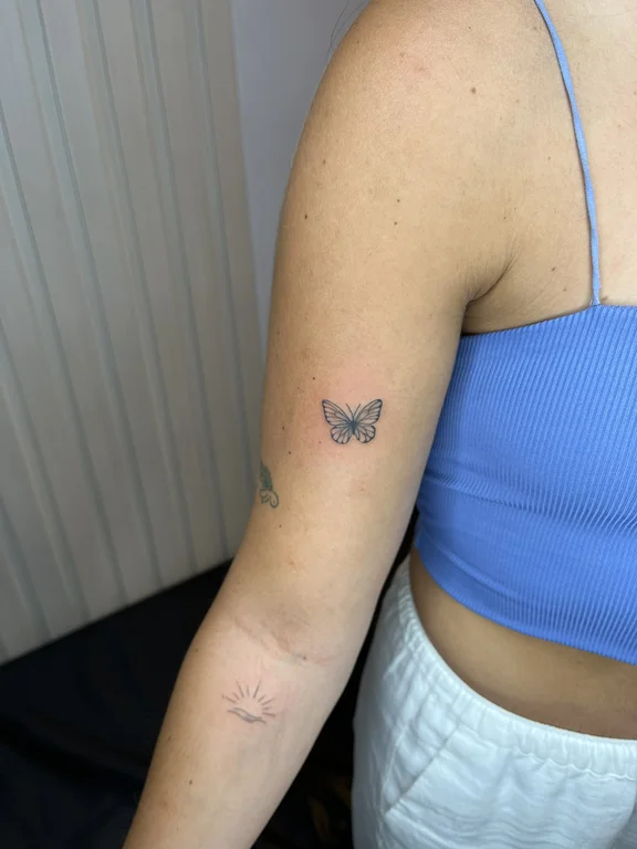 symbol minimalist butterfly soft shading minimal elegant fine line dotwork tattoo Canggu Bali