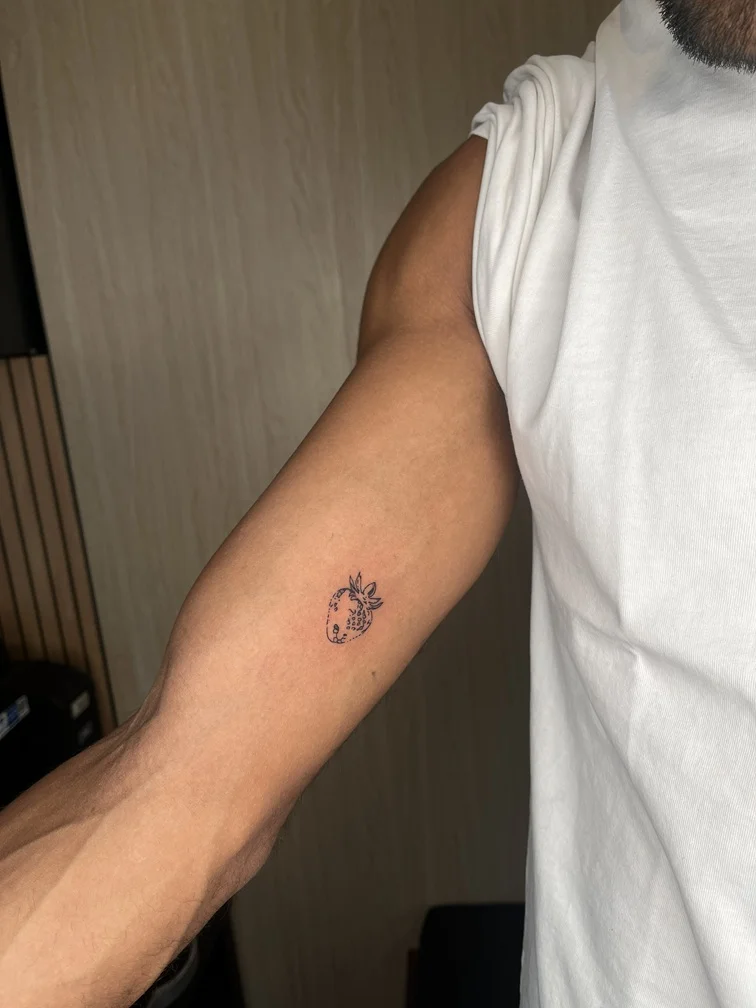 man hand strawberry black fine line fineline linework line tattoo small minimalist tattoo canggu bali