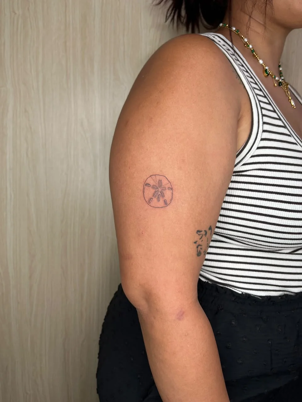 woman hand sand dollar flower minimalist fine line line work line tattoo canggu bali