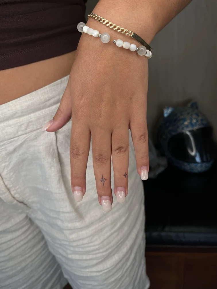 fineline line finework symbol woman finger small elegant star tattoo tattoo canggu bali