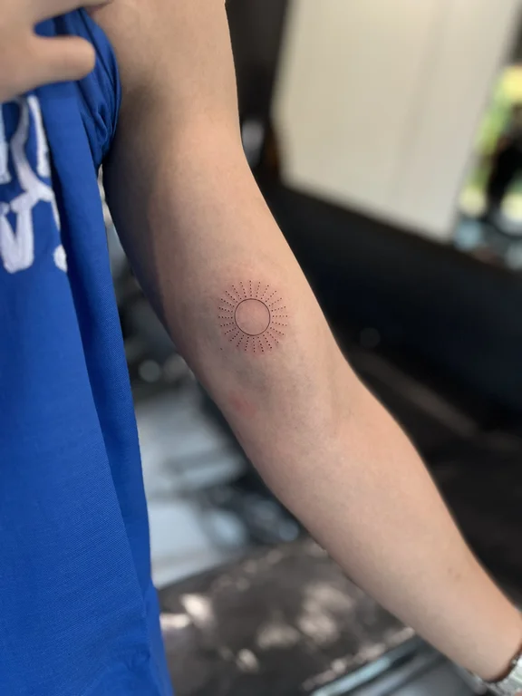 geometric minimalist man dotwork sun fine line minimal linework tattoo Canggu Bali