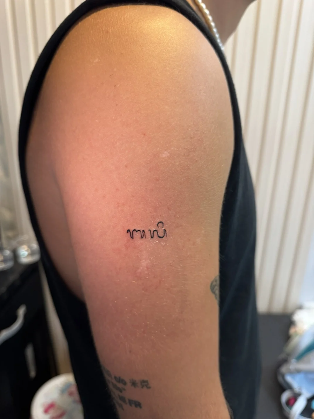 man hand minimalist lettering small fine line line work tattoo canggu bali