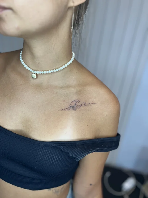 woman fine line elegant minimal wave soft shading tattoo canggu bali
