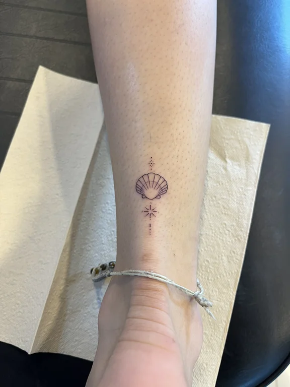 religious minimalist lotus fine line spiritual minimal dotwork elegant tattoo Canggu Bali