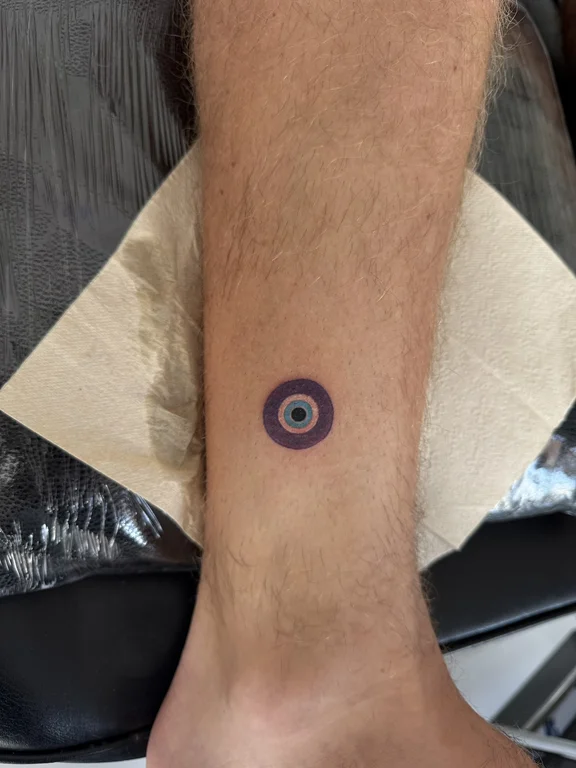 symbol minimalist eye colorful moon minimal fine line man tattoo Canggu Bali