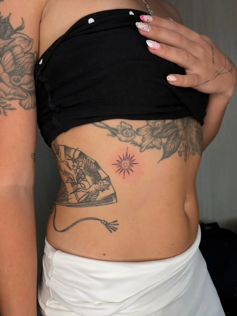woman front sun love symbol fine line line work line minimalist tattoo canggu bali