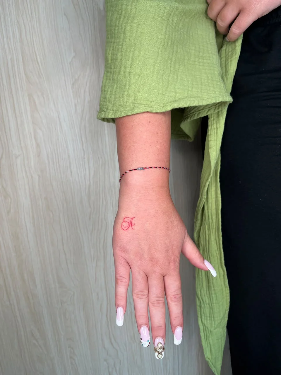 woman hand small minimalist symbol red color fine line line work line tattoo canggu bali