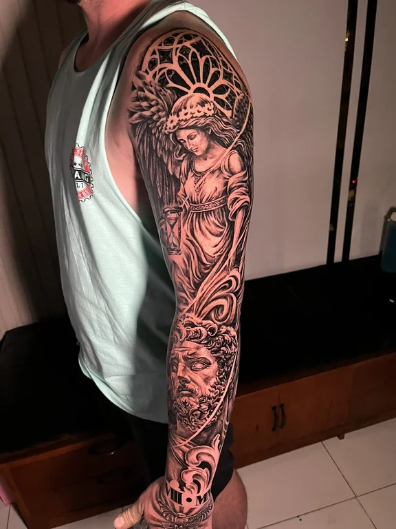 religious neo traditional angel heavy shading spiritual deity linework black grey tattoo Canggu Bali